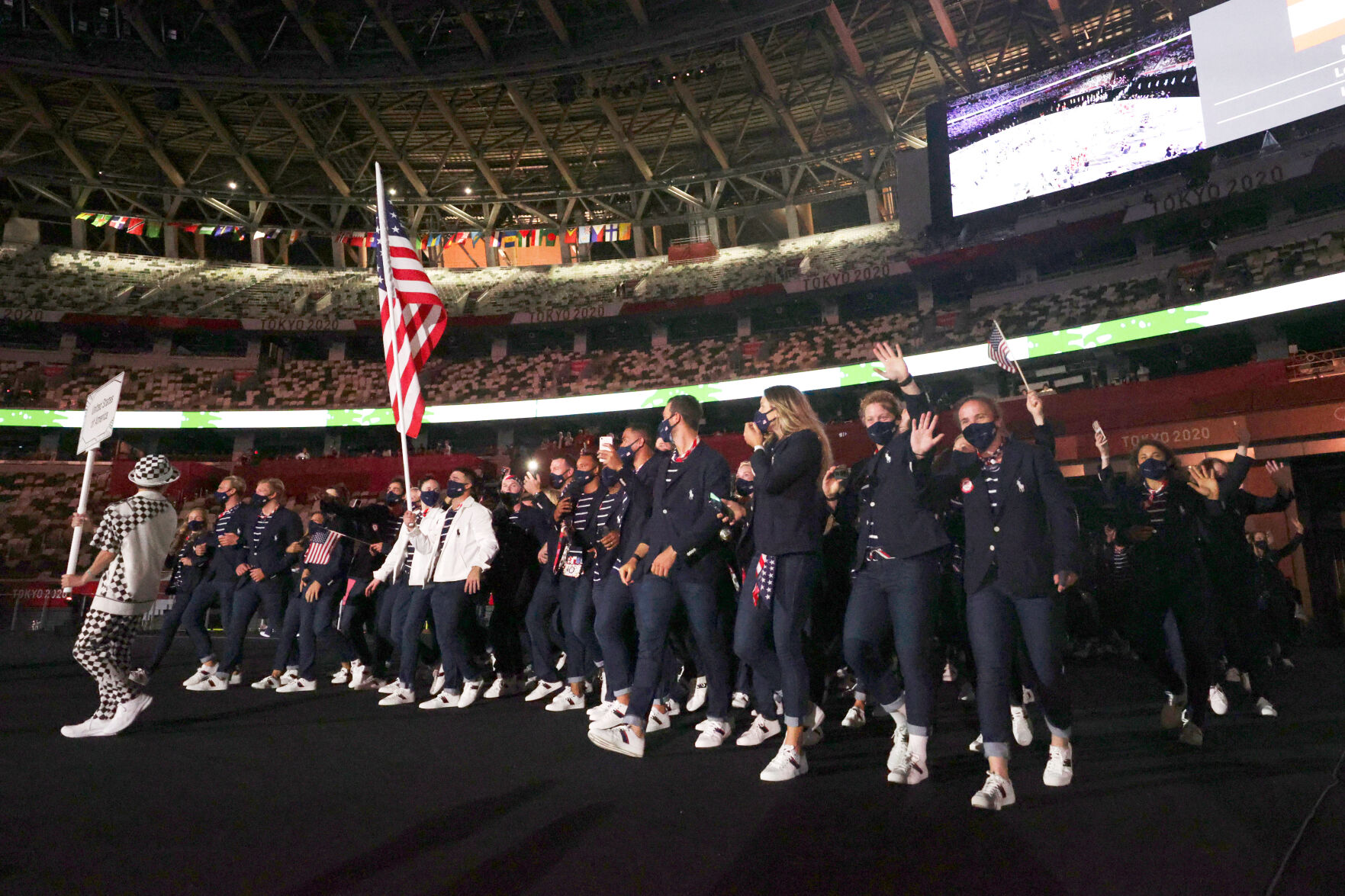 Sue Bird and Eddy Alvarez carry the flag